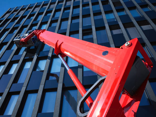 A high-rise mini crane with glass manipulator equipment  for installing double glazing for a hotel  in the United States